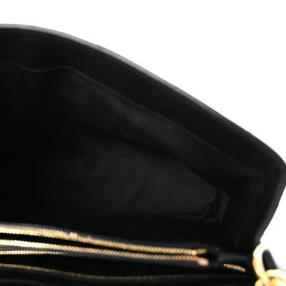 Black leather satchel interior with gold zipper trim.