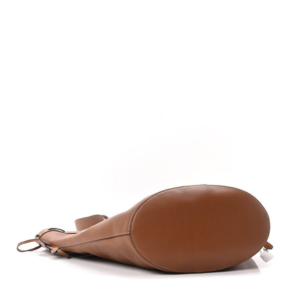 Tan-brown calfskin drawstring tote bag with rounded base and side cord ties