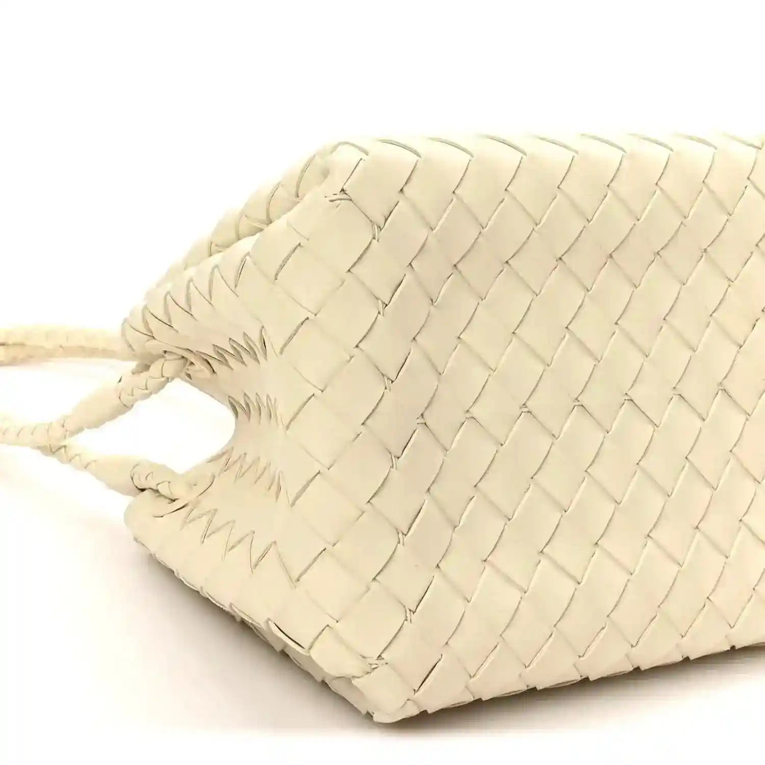 Light cream woven bag close-up with braided drawstring cord and structured base