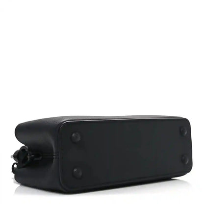 Mini black leather handbag base with corner seams and button details.