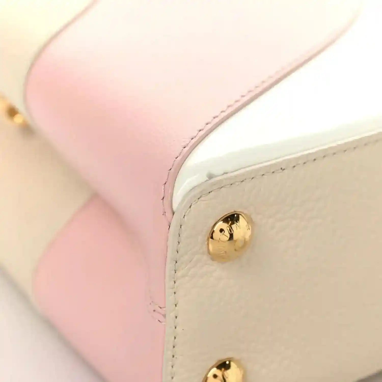 Cream leather handbag corner with gold snap button and blush pink edge panel