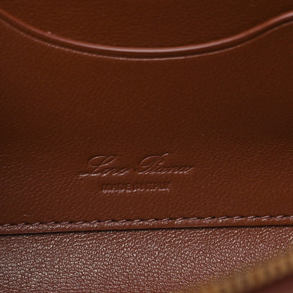Loro Piana smooth calfskin clutch with embossed logo on burnt tan leather