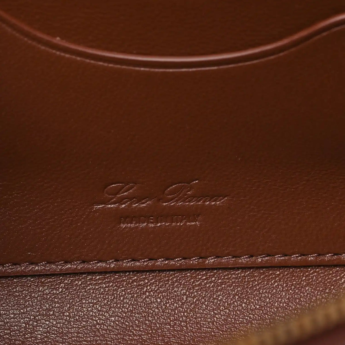 Loro Piana smooth calfskin clutch with embossed logo on burnt tan leather