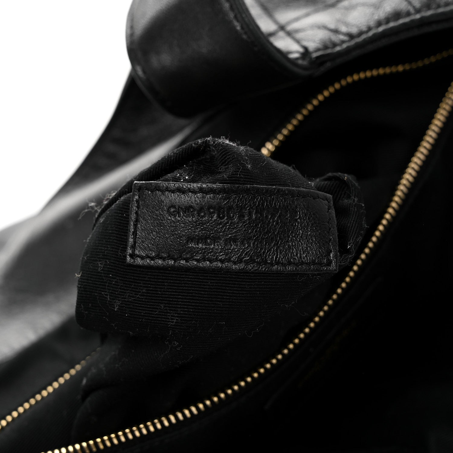 Close-up of black leather zipper lining with small interior brand label