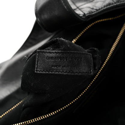 Close-up of black leather zipper lining with small interior brand label