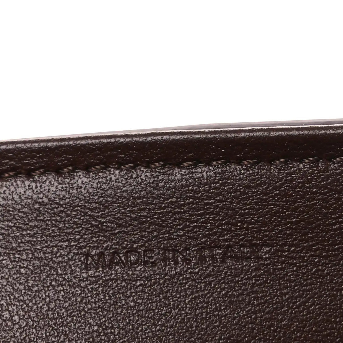 Leather edge seam with 'MADE IN' stamp.