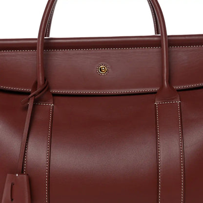 Loro Piana calfskin bag front with center snap and hanging leather key holder