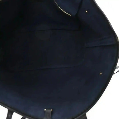 Neverfull MM tote bag interior lining with stitched seams, dark black