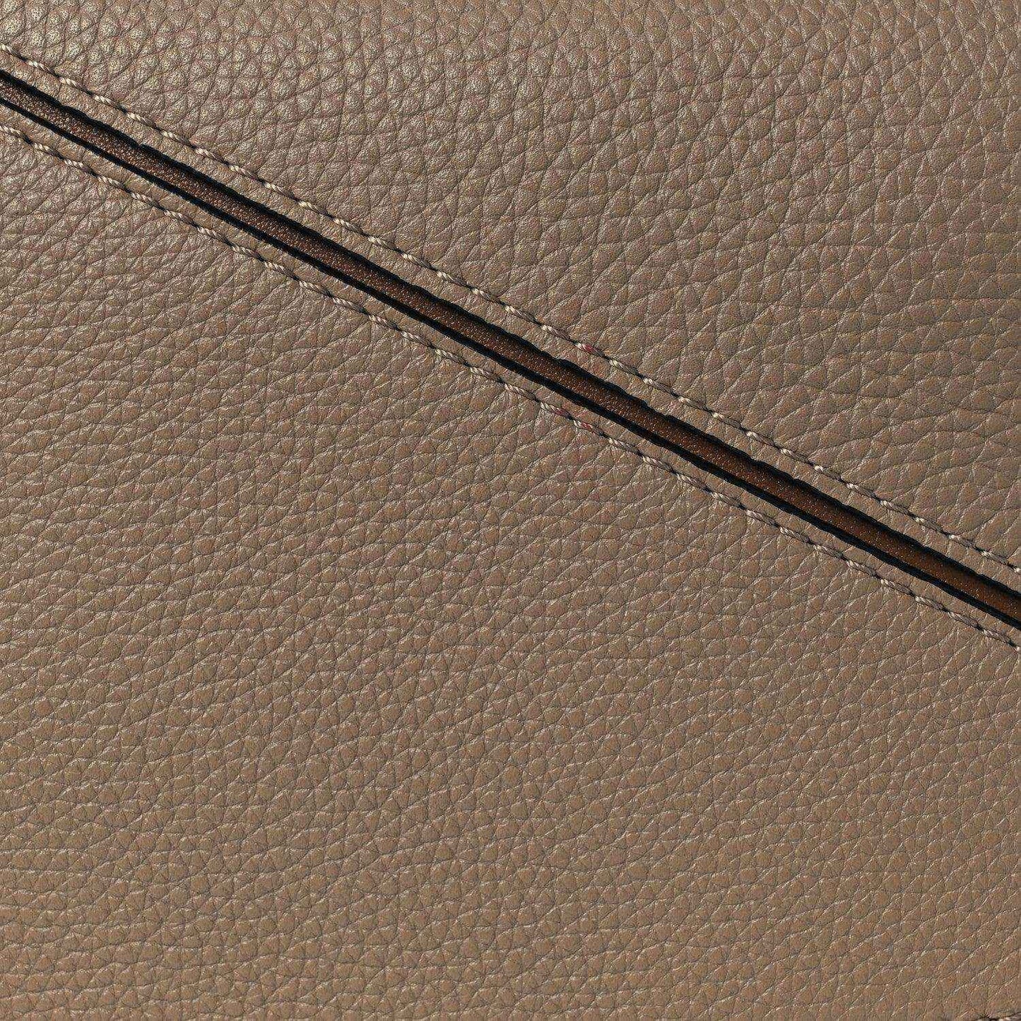 Small Puzzle bag exterior seam and grained leather edge in sand tone
