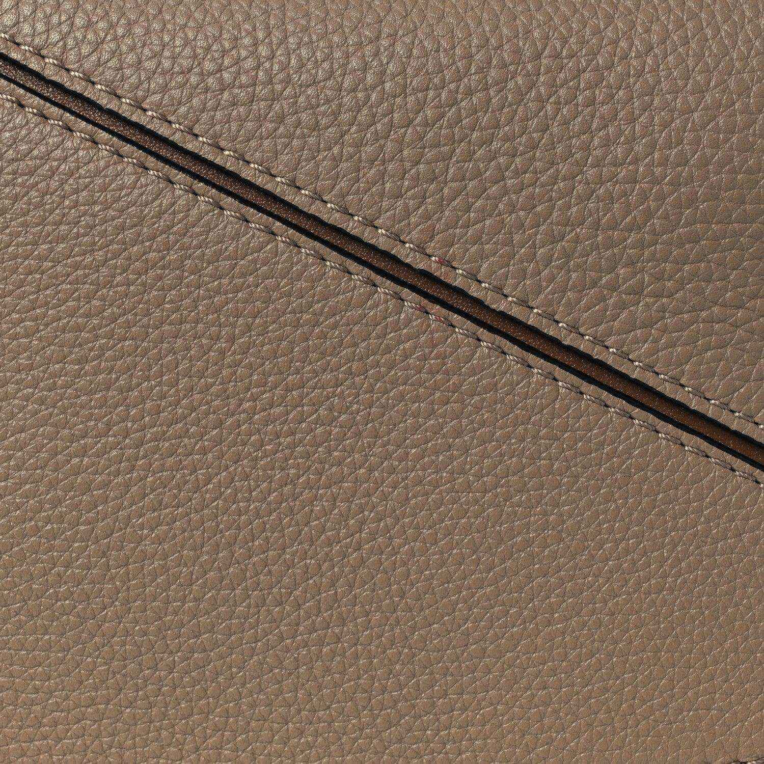 Small Puzzle bag exterior seam and grained leather edge in sand tone