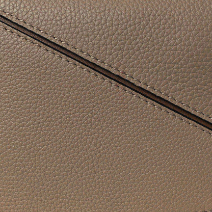 Small Puzzle bag exterior seam and grained leather edge in sand tone