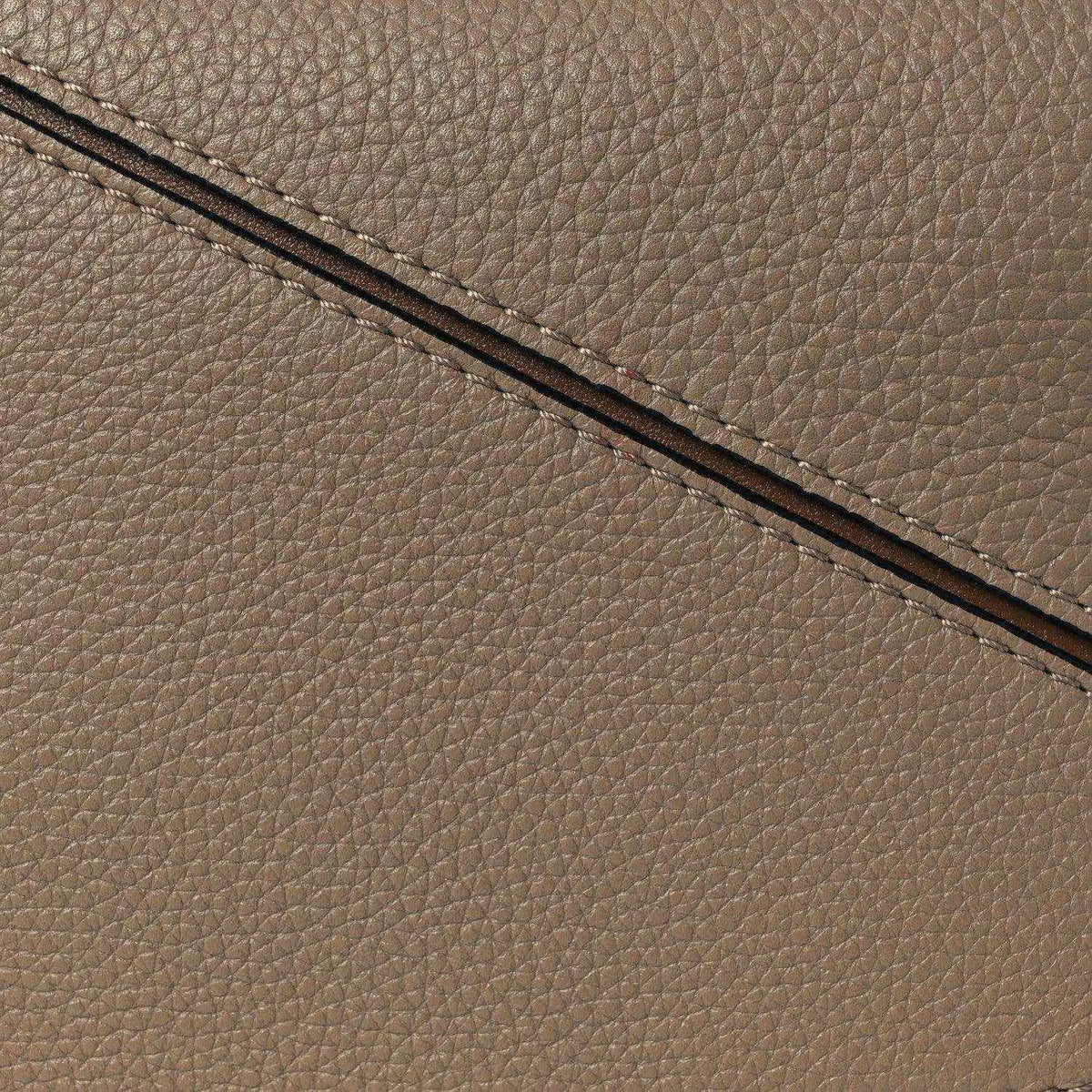Small Puzzle bag exterior seam and grained leather edge in sand tone