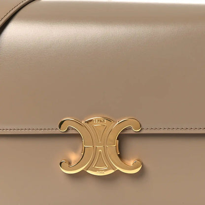 Gold Triomphe clasp emblem on shiny beige leather flap
