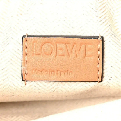 Loewe logo label on warm tan leather, rectangular stitched patch.