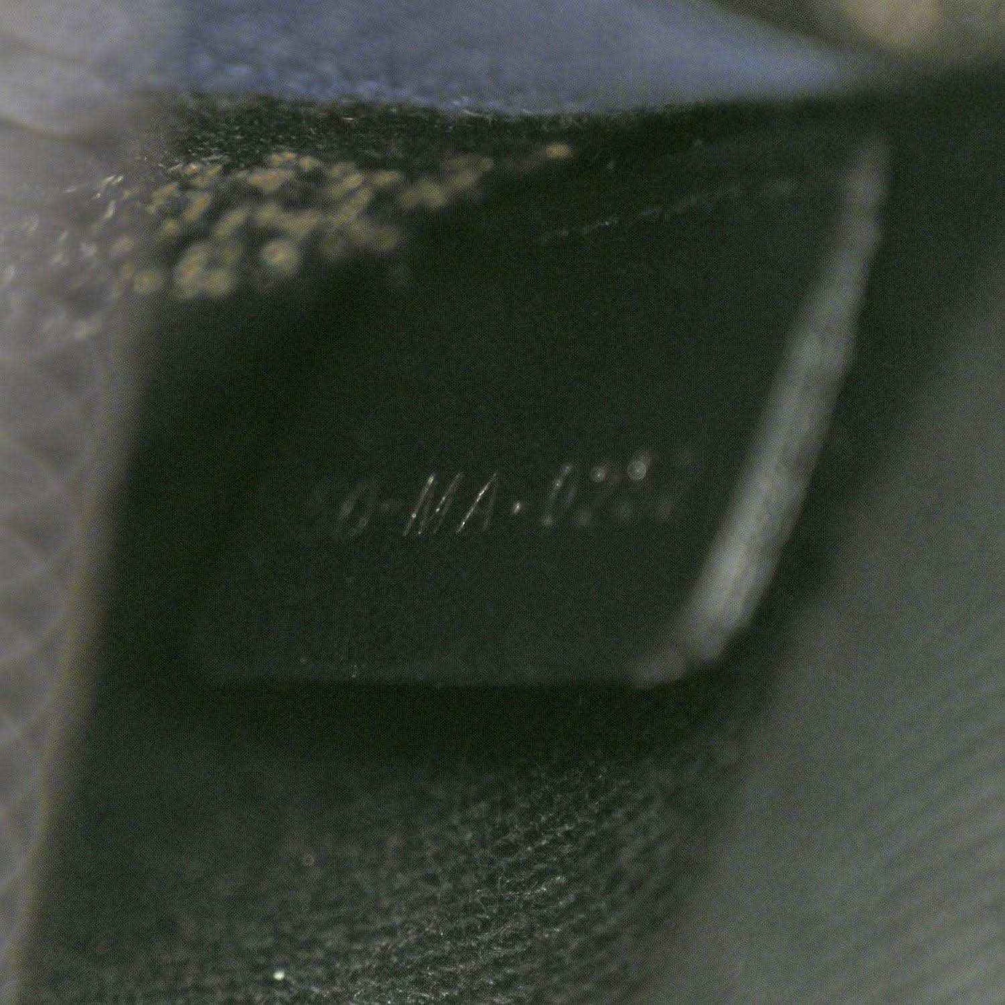 Black interior label with faint stamped text on fabric