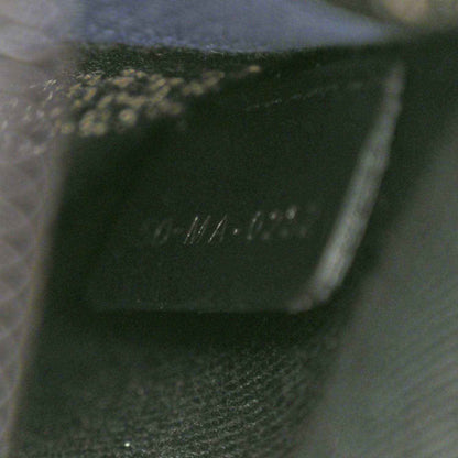 Black interior label with faint stamped text on fabric
