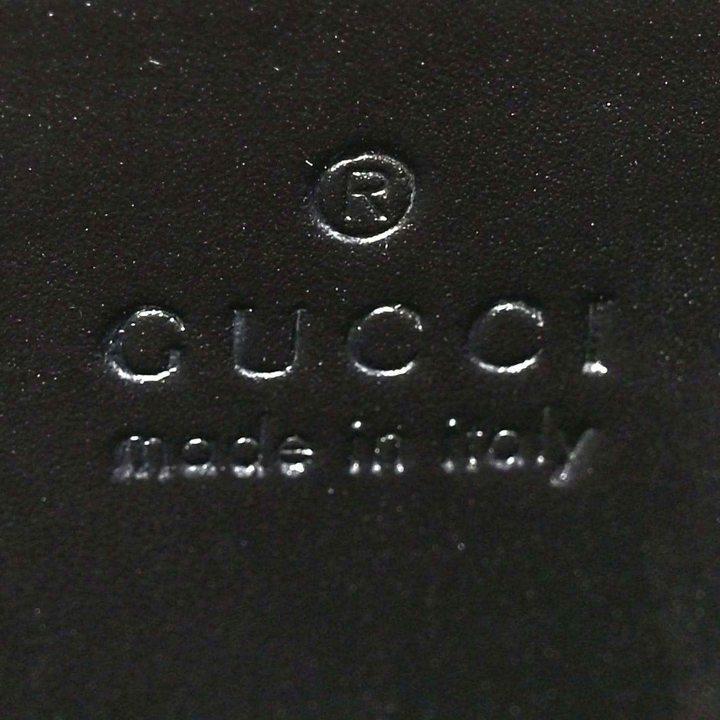 Black leather interior stamp reading Gucci and Made in Italy