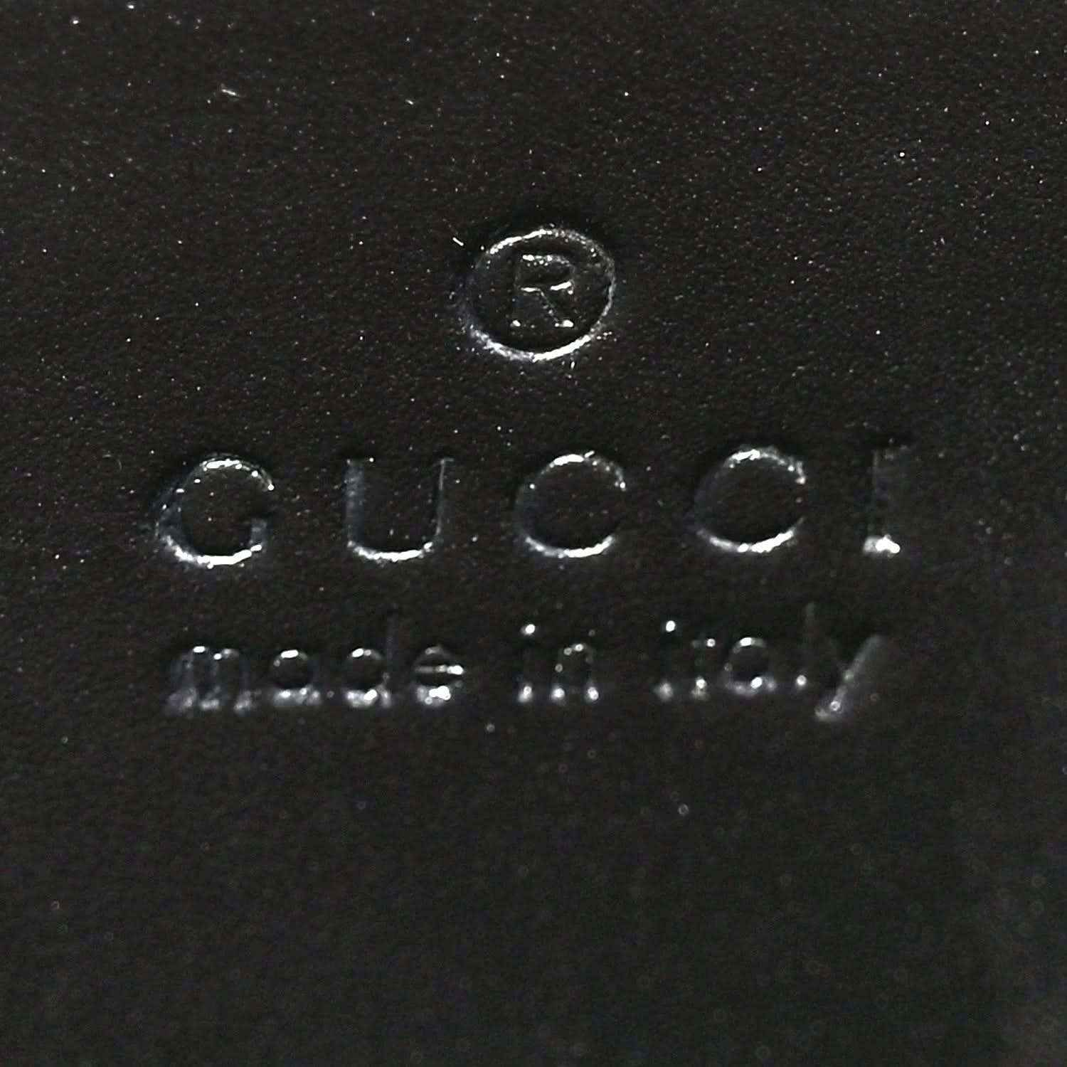 Black leather interior stamp reading Gucci and Made in Italy