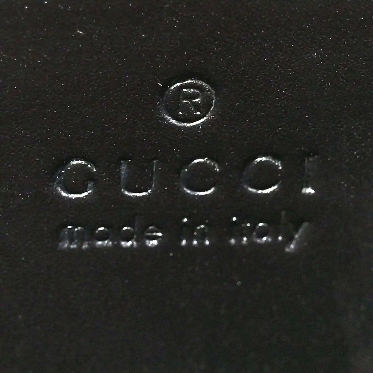 Black leather interior stamp reading Gucci and Made in Italy