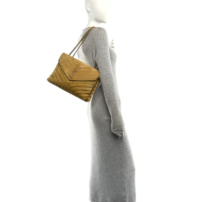 Suede quilted chartreuse satchel with gold chain strap on a mannequin