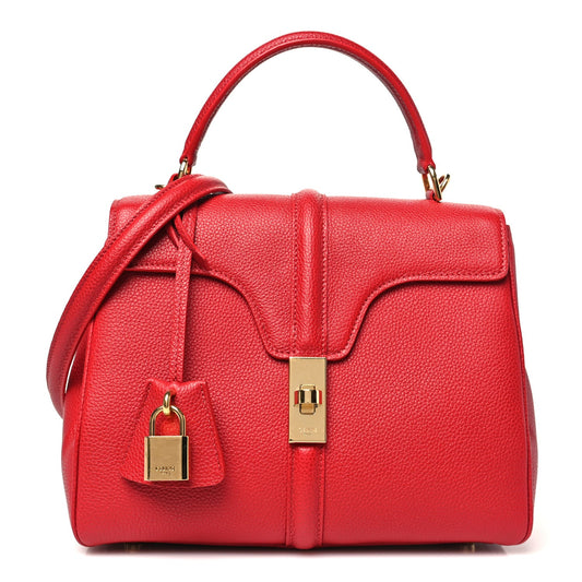 Celine small top-handle bag in red grained calfskin with front flap and lock.
