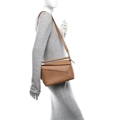 Small Puzzle Edge bag in toffee calfskin worn crossbody with adjustable strap