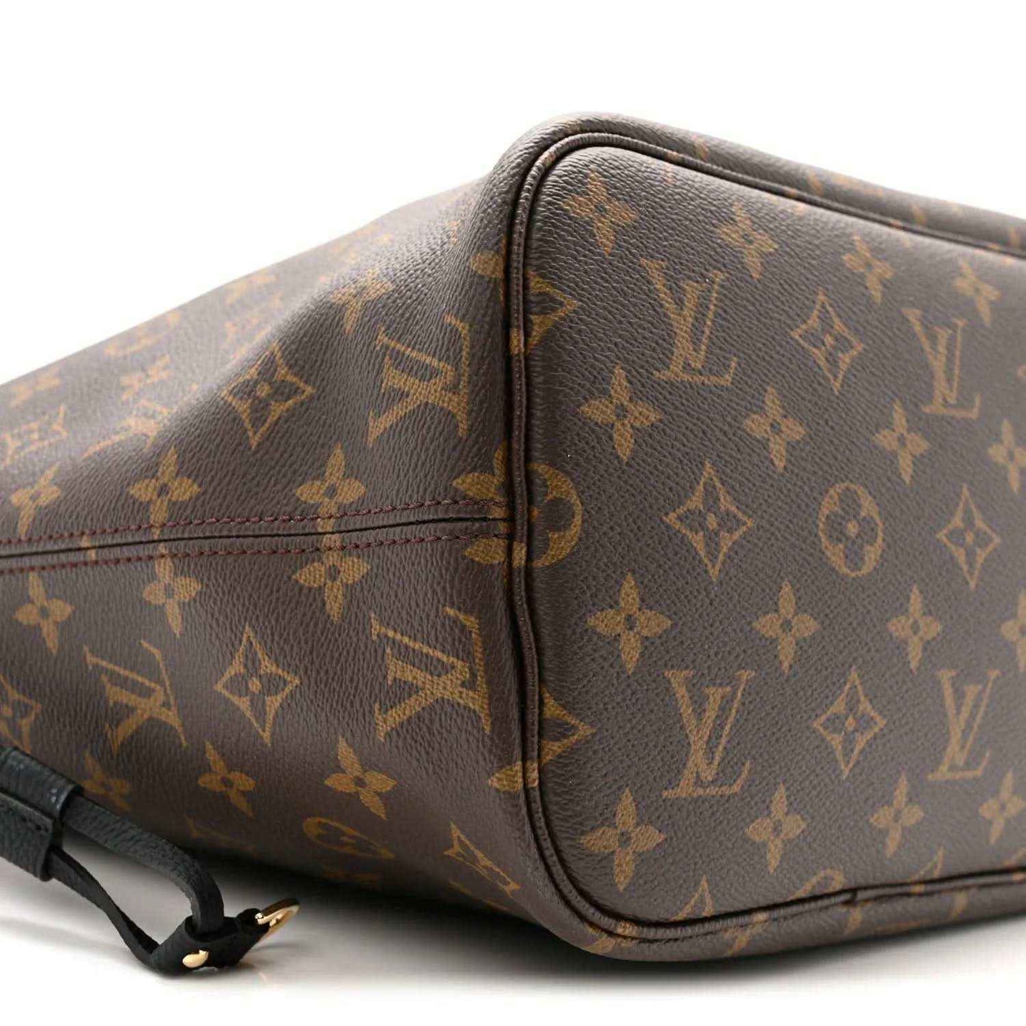 Monogram Louis Vuitton tote corner with black edge trim and strap hardware
