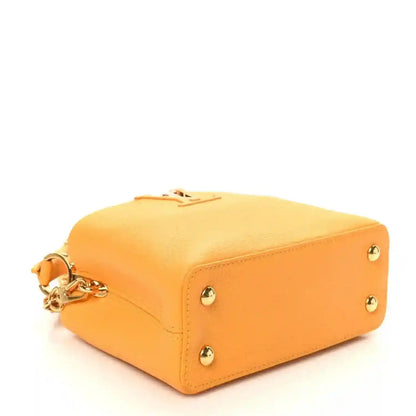 Mini Capucines handbag in yellow textured leather with gold-tone hardware and top handle