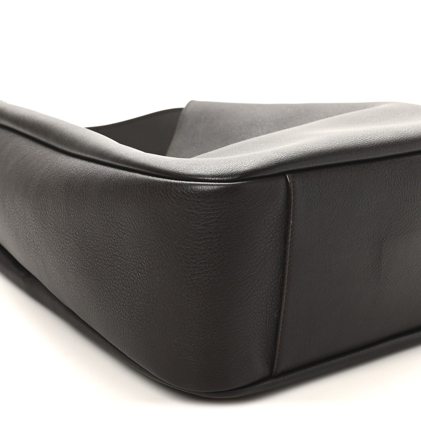 Curved side panel of dark leather hobo bag with folded top edge
