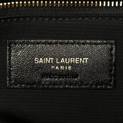 Dark grained lambskin satchel label with SAINT LAURENT PARIS stamp