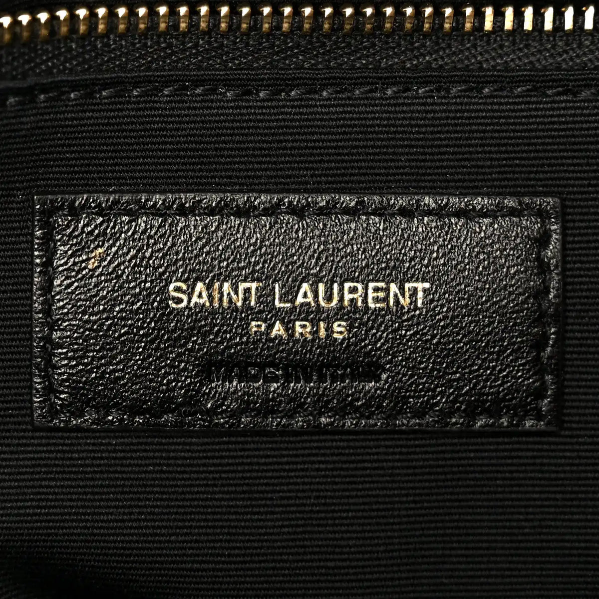 Dark grained lambskin satchel label with SAINT LAURENT PARIS stamp
