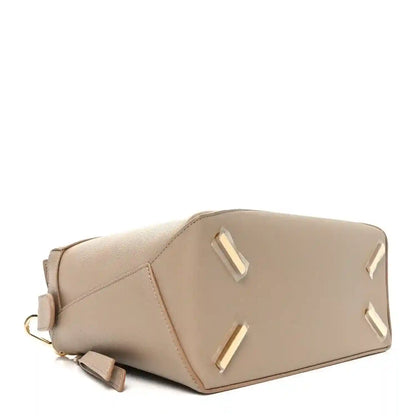 Large leather puzzle edge bag in sand with top handle and gold-tone hardware.
