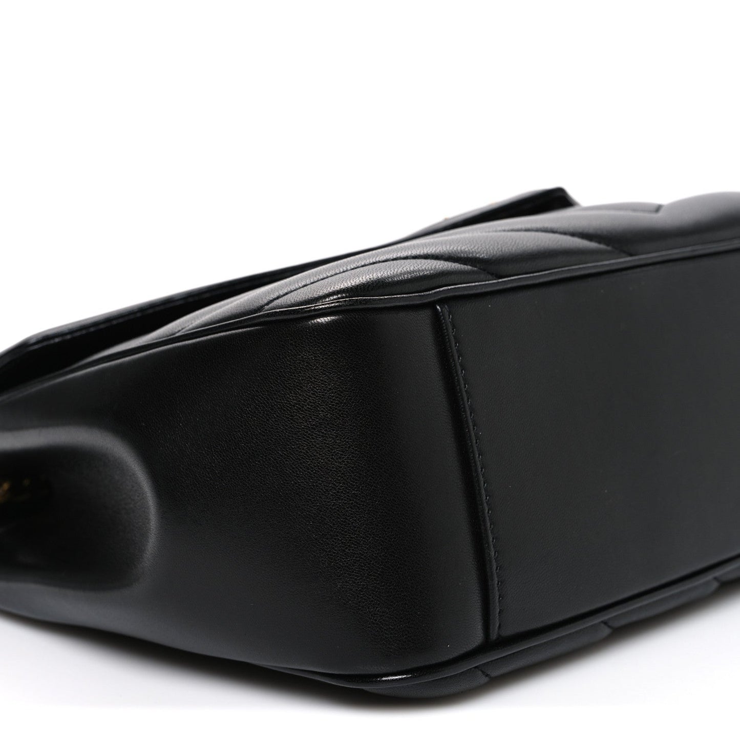 Black leather shoulder bag end panel with smooth edge and subtle grain texture