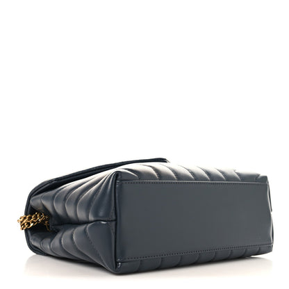 Saint Laurent quilted leather satchel side profile with gold chain strap, dark blue