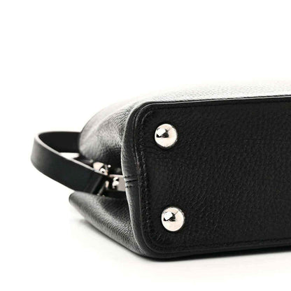 Black leather handbag end with two silver studs and crossbody strap