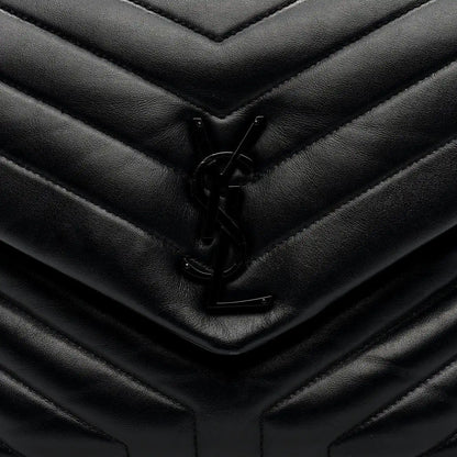 Black quilted satchel front flap with YSL logo clasp detail