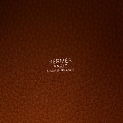 Cognac brown pebbled leather panel with stamped brand text