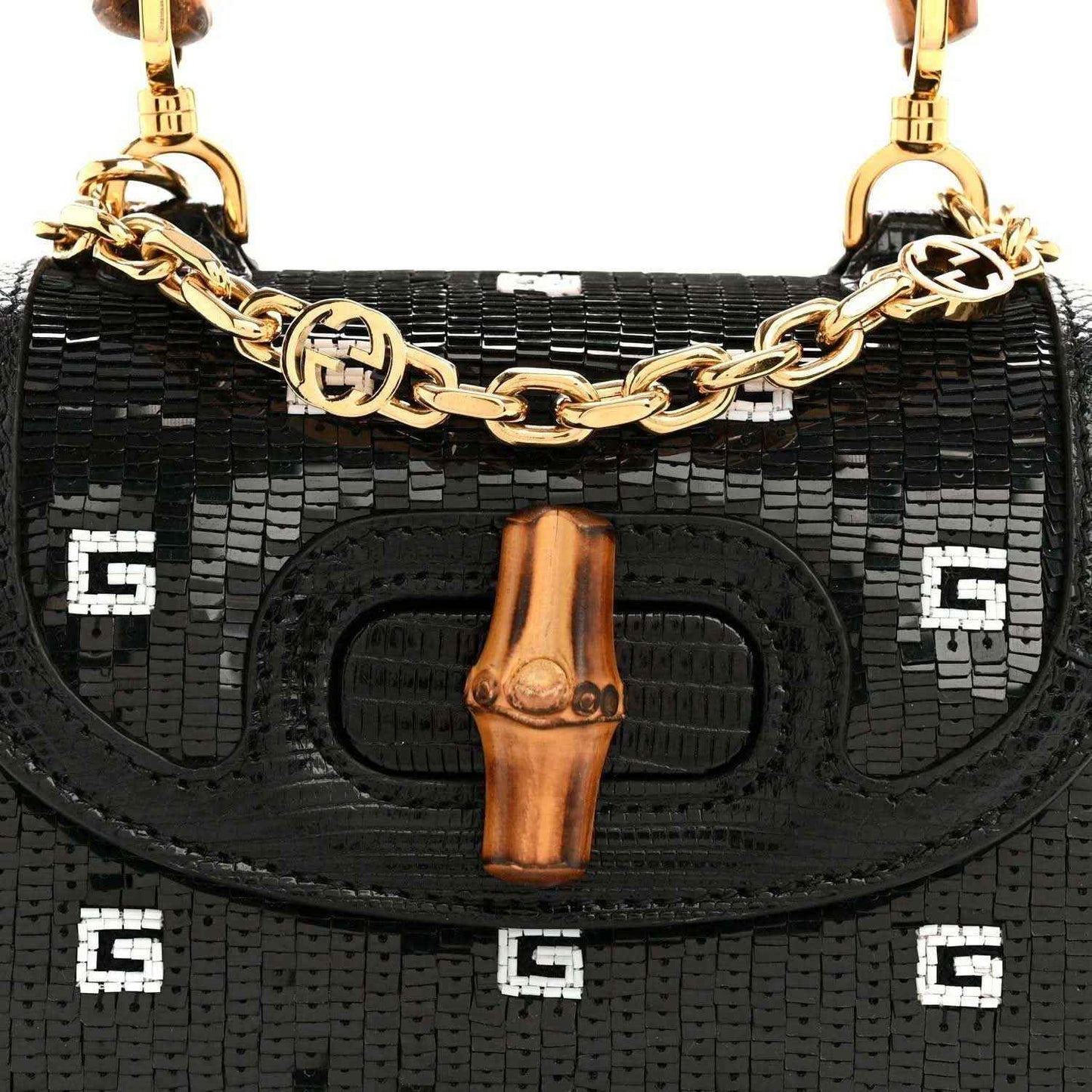 Gucci mini top handle bag front, black embossed lizard texture, bamboo tab and gold chain