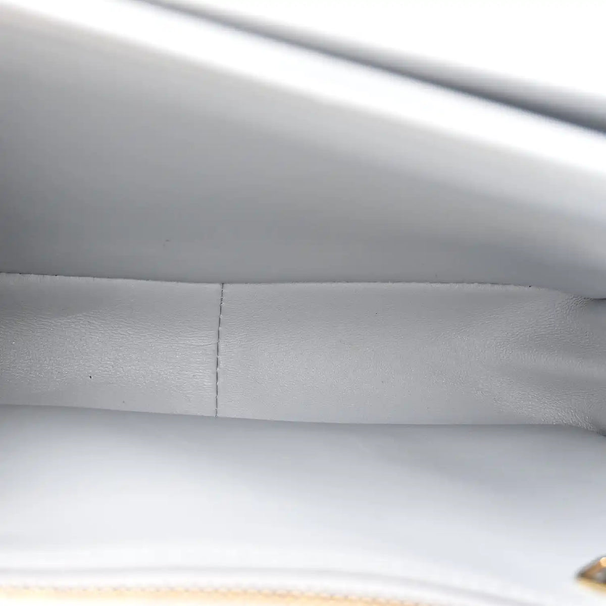 Shiny calfskin bag interior seam and lining close-up