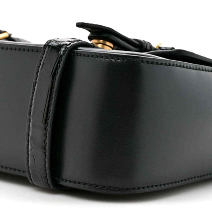 Black leather messenger bag close-up of side panel and stitched edging