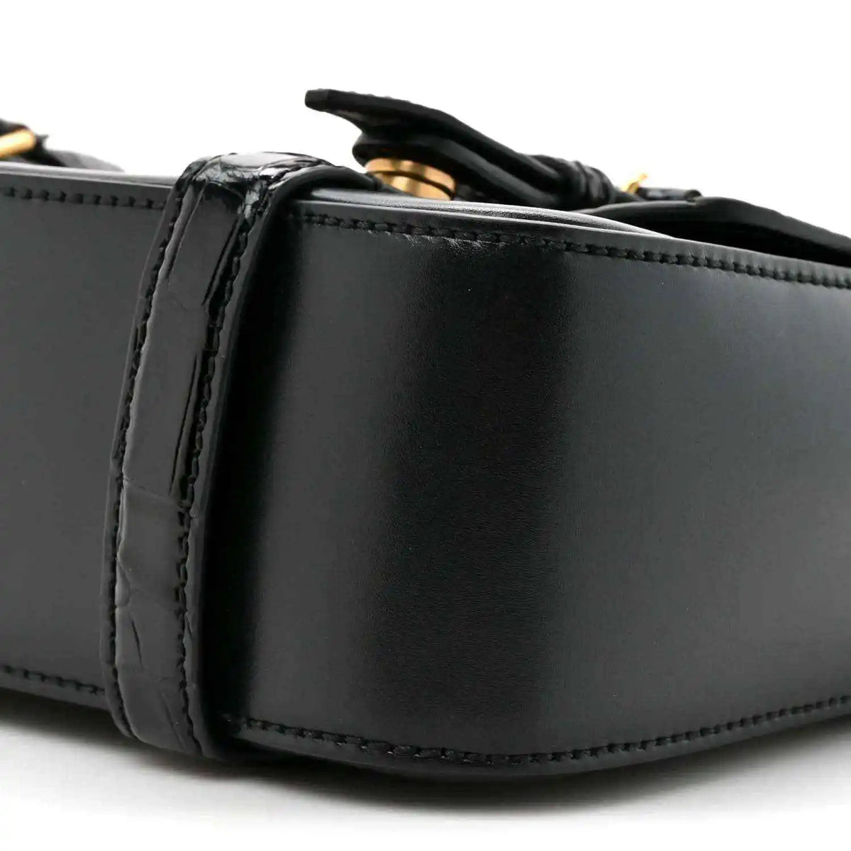 Black leather messenger bag close-up of side panel and stitched edging