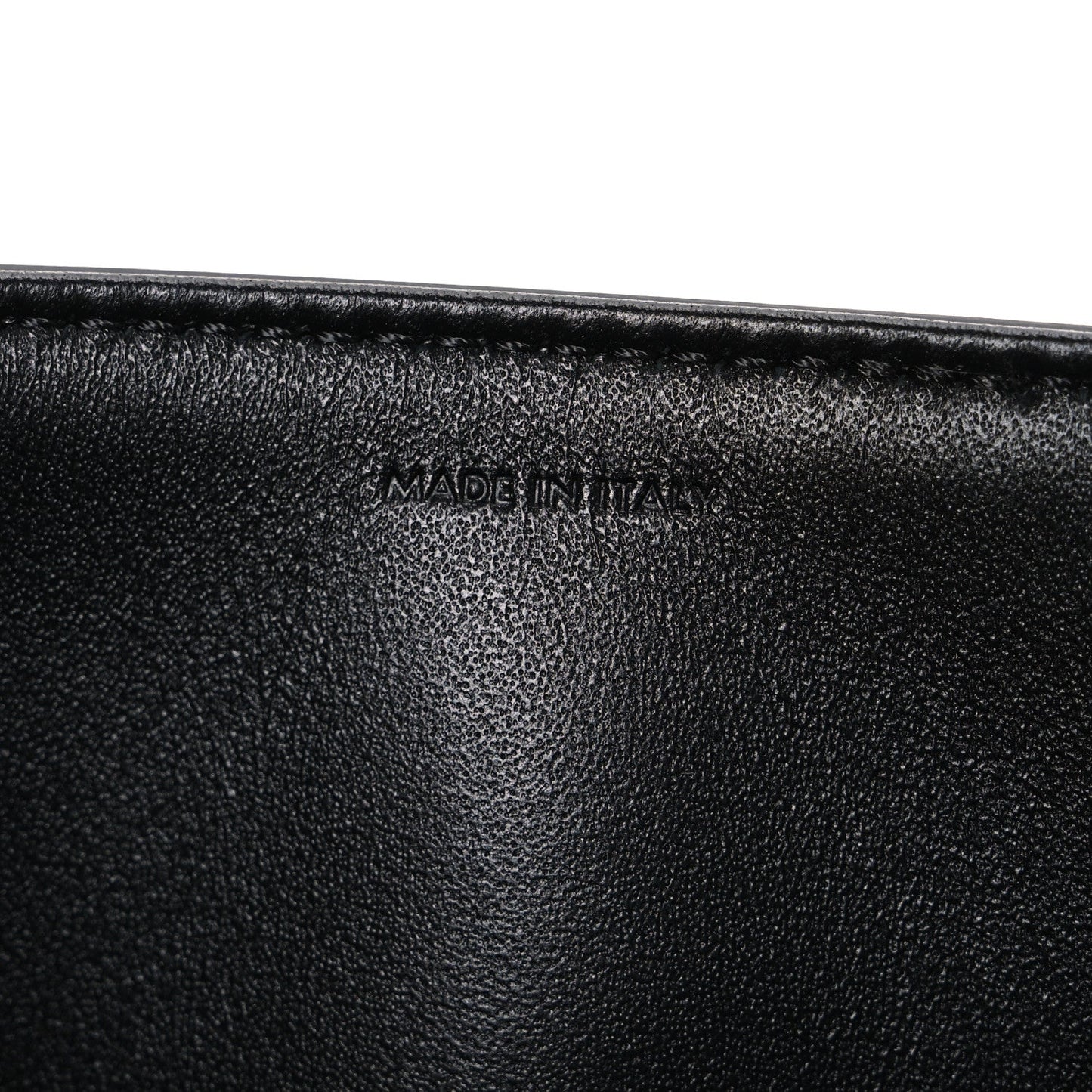 Shiny calfskin medium shoulder bag, black interior close-up with “Made in Italy” stamp