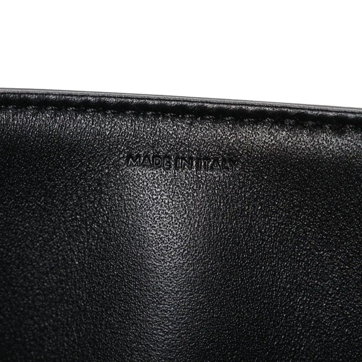 Shiny calfskin medium shoulder bag, black interior close-up with “Made in Italy” stamp