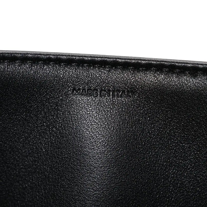 Shiny calfskin medium shoulder bag, black interior close-up with “Made in Italy” stamp