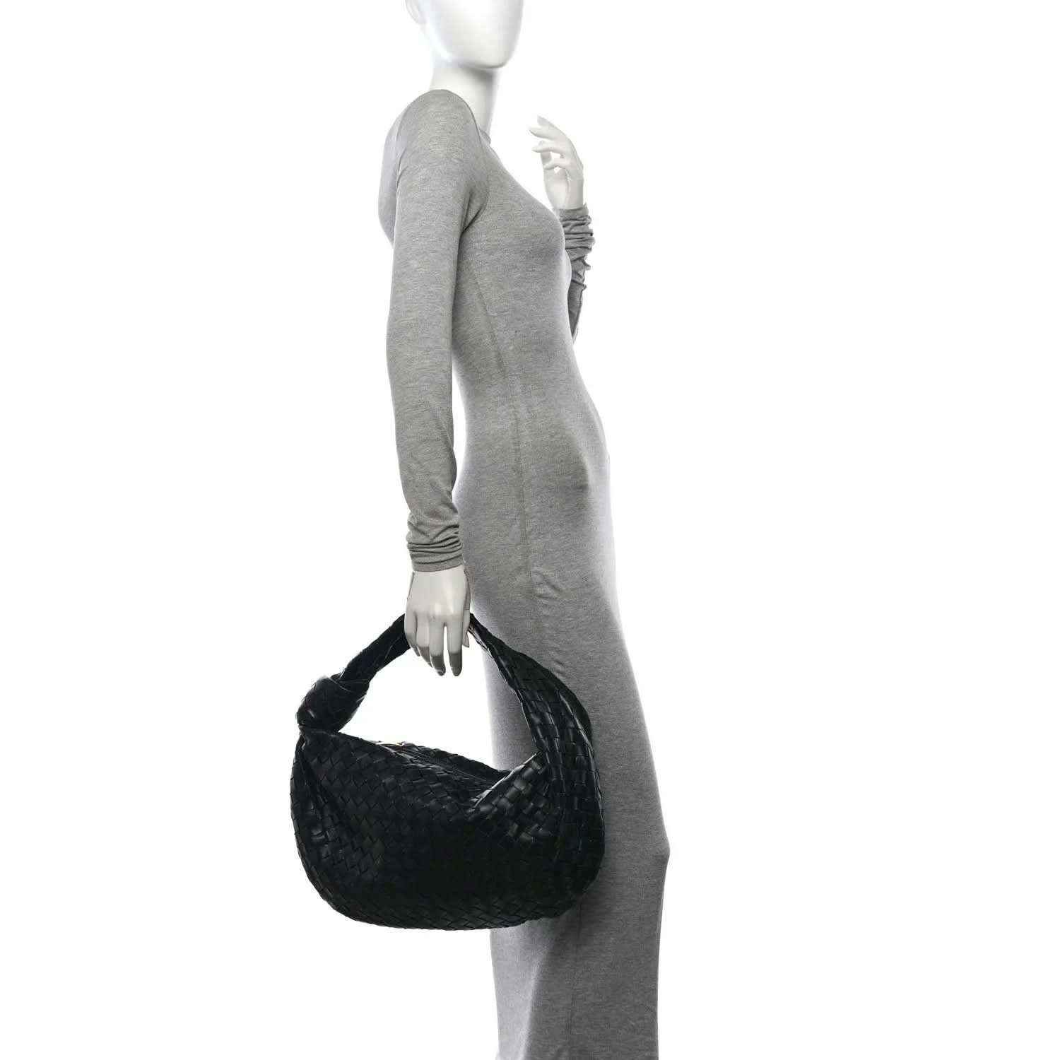 Small black leather shoulder bag on model, intrecciato woven texture