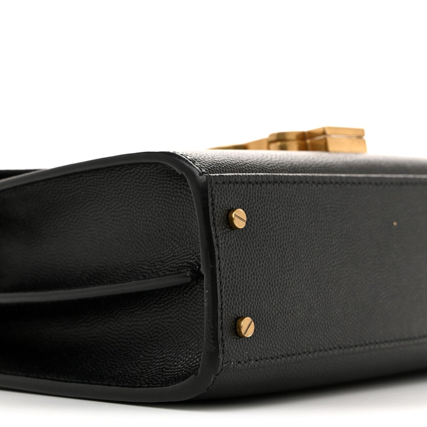 Black leather mini bag with structured flap and gold-tone stud accents.