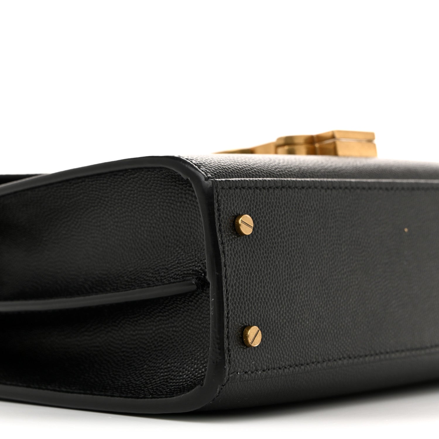 Black leather mini bag with structured flap and gold-tone stud accents.