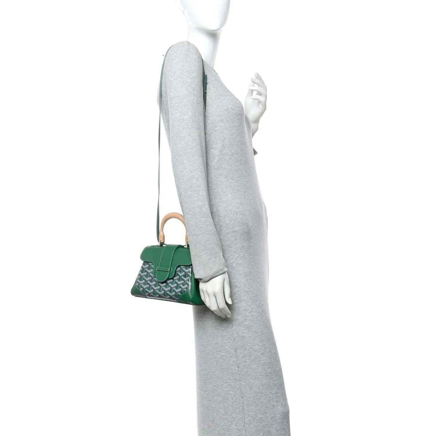 Green mini Saigon bag shown side-on with thin shoulder strap and compact flap