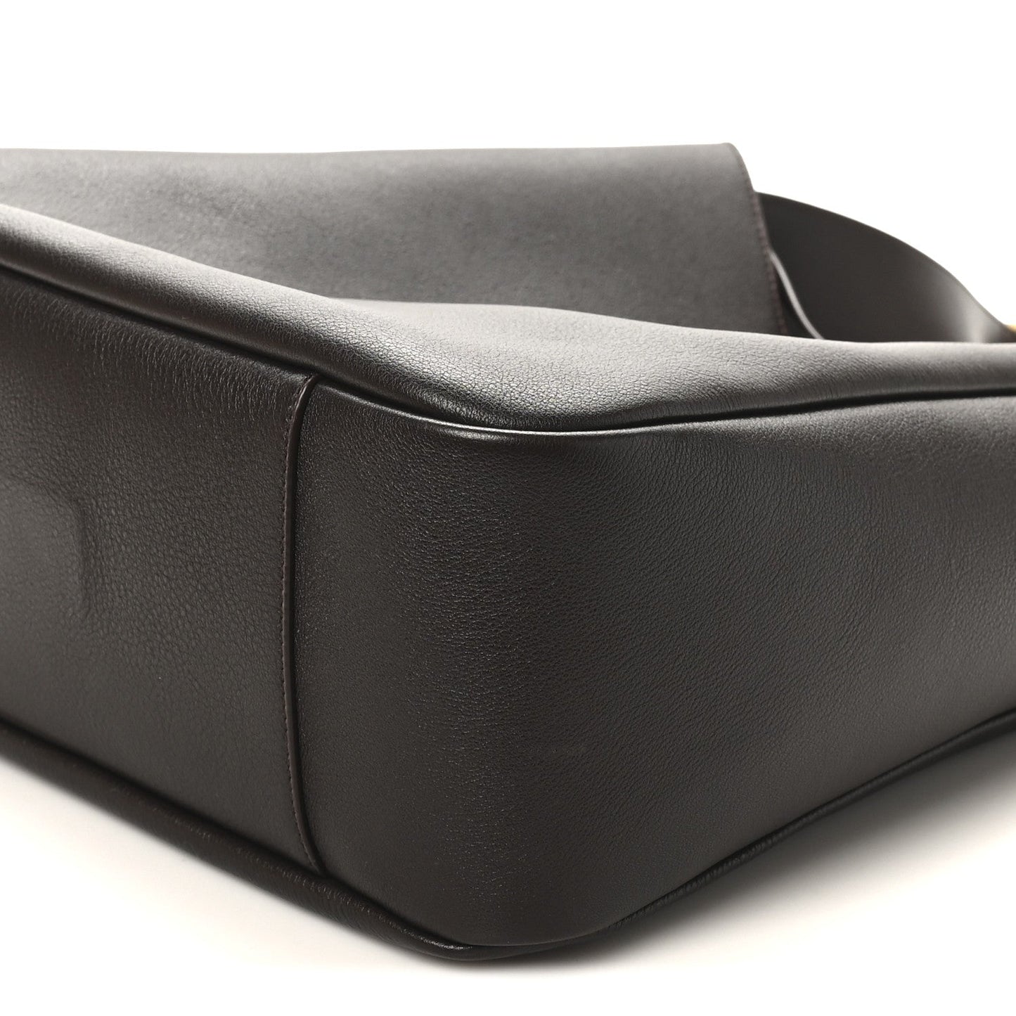 Corner and side seam of dark leather hobo bag with rounded base