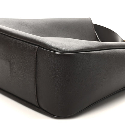 Corner and side seam of dark leather hobo bag with rounded base